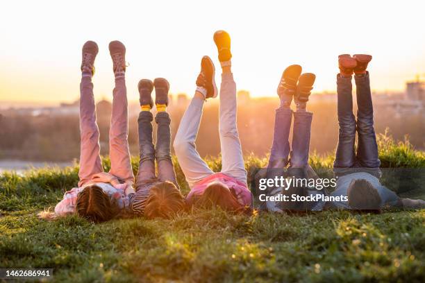 group of children enjoys in nature - feet up stock pictures, royalty-free photos & images