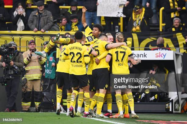 Sebastien Haller of Borussia Dortmund celebrates with team mates after scoring their sides third goal during the Bundesliga match between Borussia...