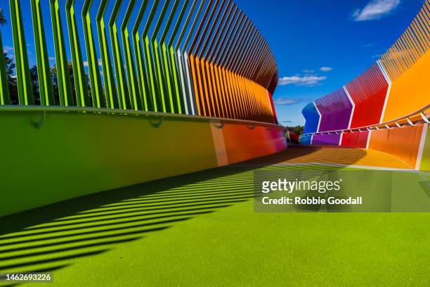 rainbow-coloured pedestrian bridge - catwalk background stock pictures, royalty-free photos & images