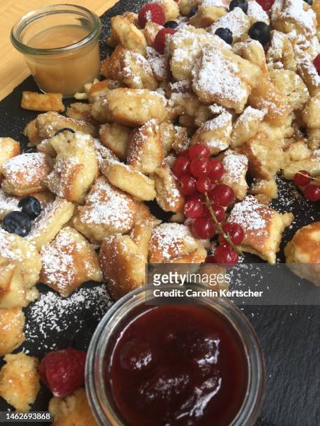 kaiserschmarren with apple and berry sauce - kaiserschmarrn stock pictures, royalty-free photos & images