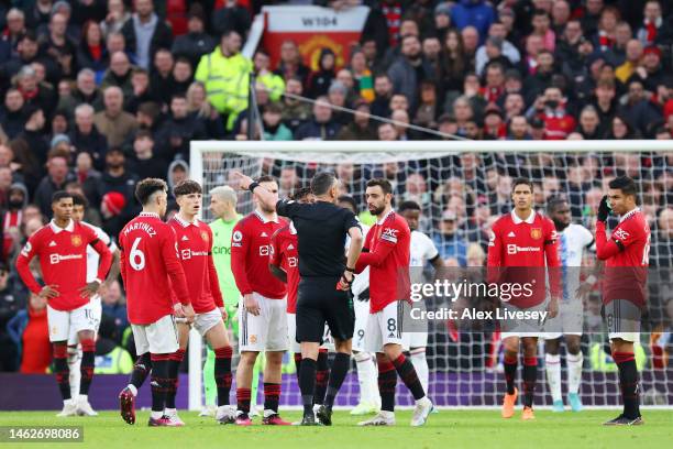 Match referee Andre Marriner shows a red card to Casemiro of Manchester United during the Premier League match between Manchester United and Crystal...