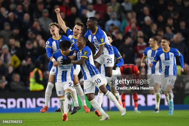 Kaoru Mitoma of Brighton & Hove Albion celebrates with team mates after scoring their sides first goal during the Premier League match between...