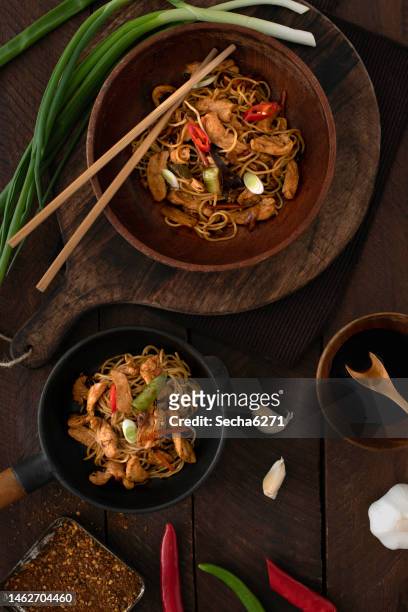 chicken  noodles in a bowl on a rustic background - szechuan cuisine stock pictures, royalty-free photos & images