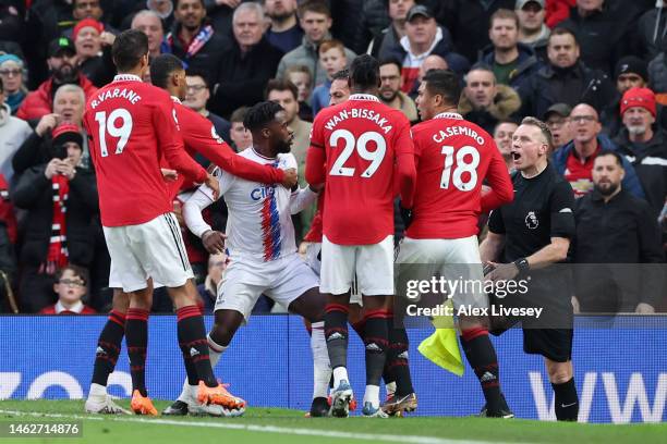 Casemiro of Manchester United clashes with Jeffrey Schlupp of Crystal Palaceduring the Premier League match between Manchester United and Crystal...