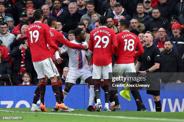 Casemiro of Manchester United clashes with Jeffrey Schlupp of Crystal Palaceduring the Premier League match between Manchester United and Crystal...