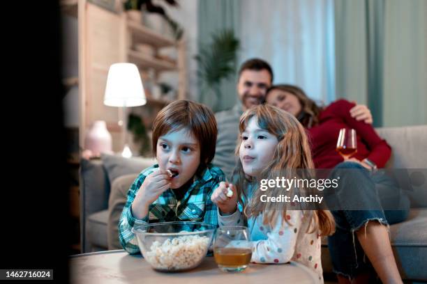 brother and sister eating popcorn - image type stock pictures, royalty-free photos & images