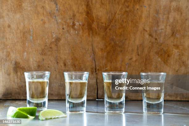 row of tequila shots - shot glass stock pictures, royalty-free photos & images