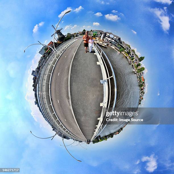 a couple in zaanse schans, netherlands, little planet effect - 360 degree view stockfoto's en -beelden