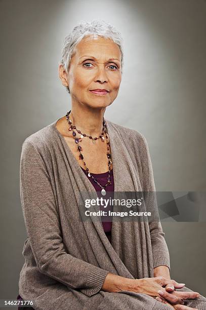 portrait of senior woman smiling, studio shot - confidence studio shot foto e immagini stock