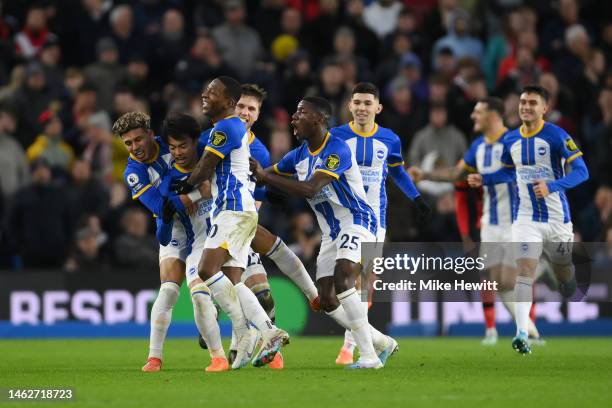 Kaoru Mitoma of Brighton & Hove Albion celebrate with team mates after scoring their sides first goal during the Premier League match between...