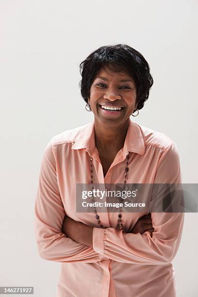 portrait of smiling african american mature woman, studio shot - black blouse stock pictures, royalty-free photos & images