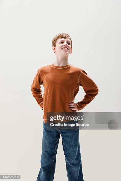 boy in brown sweater in superhero stance, studio shot - kid studio shot stock pictures, royalty-free photos & images