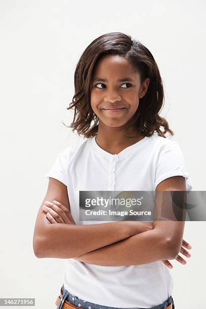 african american girl looking away, studio shot - girl standing crossed arms studio stock pictures, royalty-free photos & images