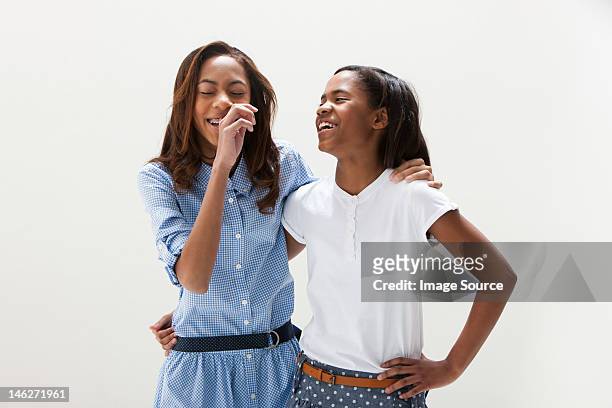 african american sisters standing together, studio shot - two people studio shot stock pictures, royalty-free photos & images