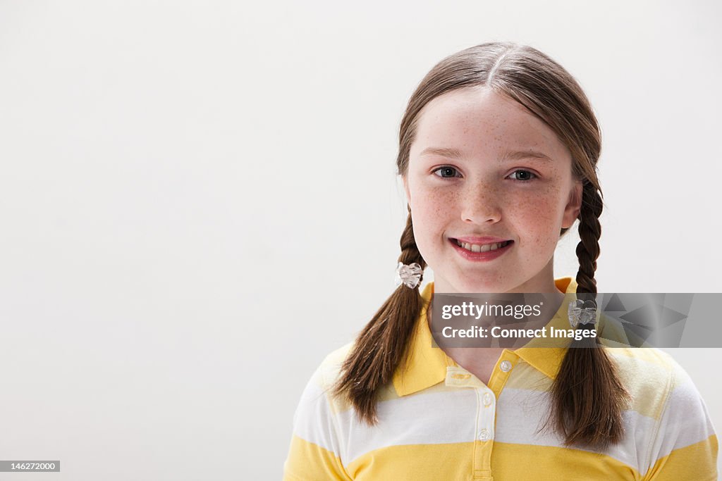 Portrait of girl smiling, studio shot