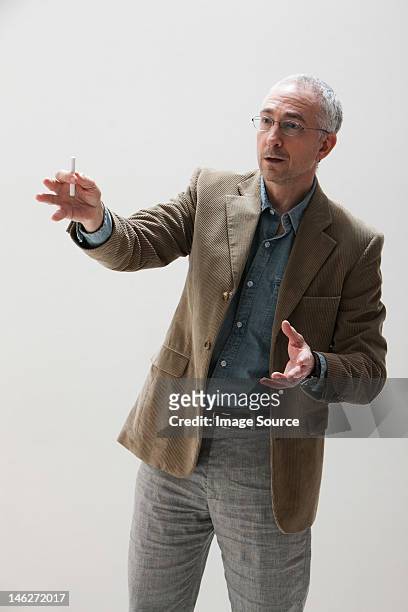 mature man gesturing, studio shot - three quarter length stock pictures, royalty-free photos & images
