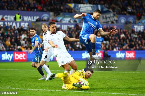 Andy Fisher of Swansea collects the ball at the feet of Lukas Jutkiewicz of Birmingham during the Sky Bet Championship between Swansea City and...