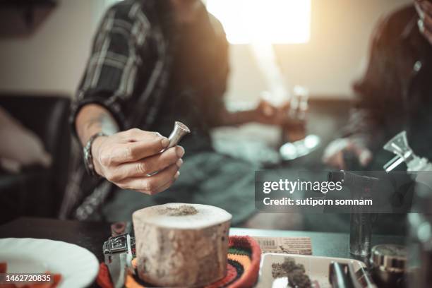 cannabis ready to smoke with a bong - asian man smoking stock pictures, royalty-free photos & images