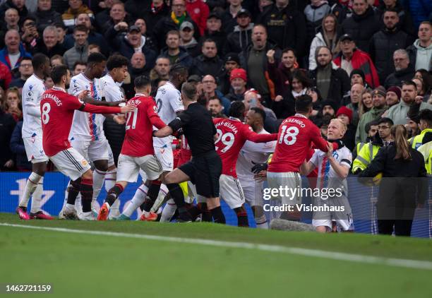 Casemiro of Manchester United grabs Will Hughes of Crystal Palace leading to a red card while players from both teams tussle during the Premier...
