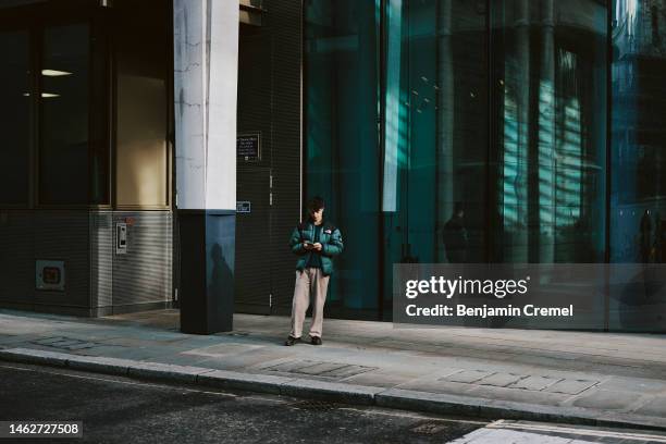 Man looks at his phone on February 3, 2023 in London, England. Today, the Bank of England upped its base interest rate from 3.5% to 4%, the highest...