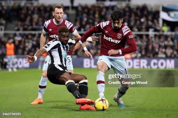 Allan Saint-Maximin of Newcastle United tackles Lucas Paqueta of West Ham United during the Premier League match between Newcastle United and West...