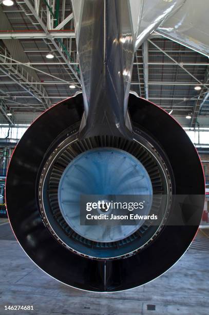 the blue titanium exhaust plug of a rolls royce a380 jet engine. - airplane part stock-fotos und bilder