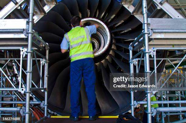 a jet airliner turbofan engine repaired by an aeronautical engineer. - titanium stock pictures, royalty-free photos & images