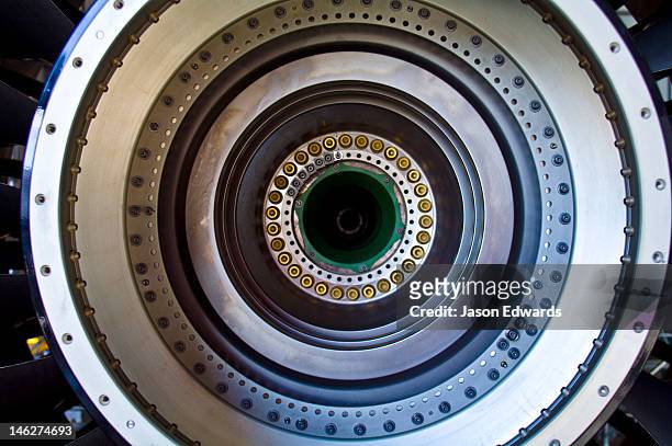 the stainless steel spinning shaft of a jet airliner turbofan engine. - nut fastener stock-fotos und bilder