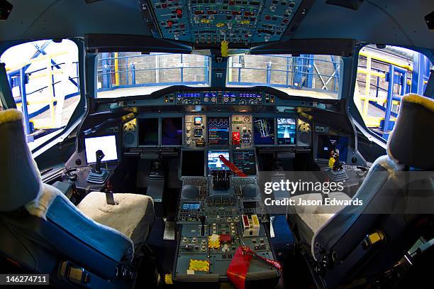 the flight controls and led screens in the cockpit of a jet airliner. - seat perilous fotografías e imágenes de stock