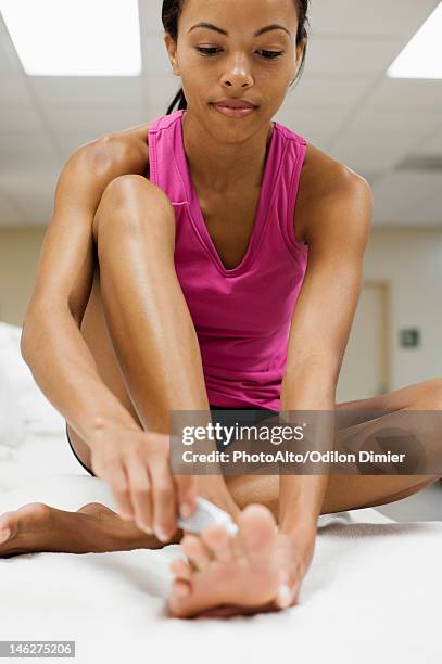 woman applying ointment on foot - athlete's foot stock pictures, royalty-free photos & images