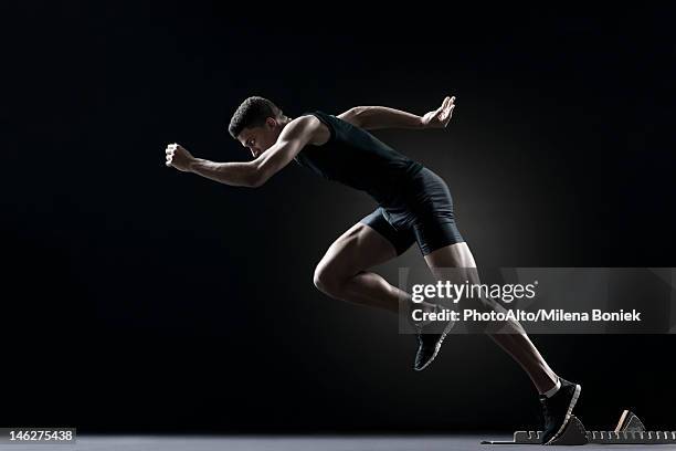 runner leaving starting block - starting block stock pictures, royalty-free photos & images