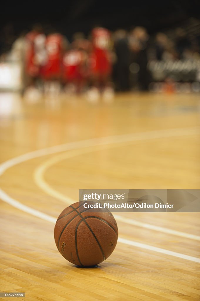 Basketball resting on court