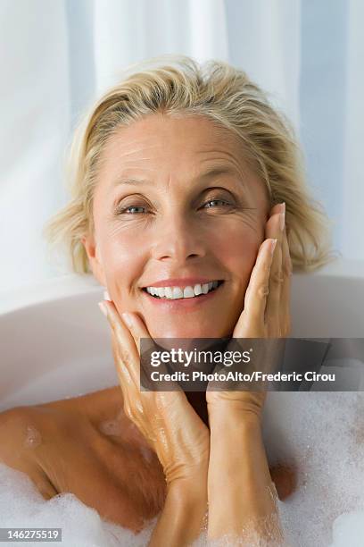mature woman enjoying bubble bath, portrait - beautiful woman bath stockfoto's en -beelden