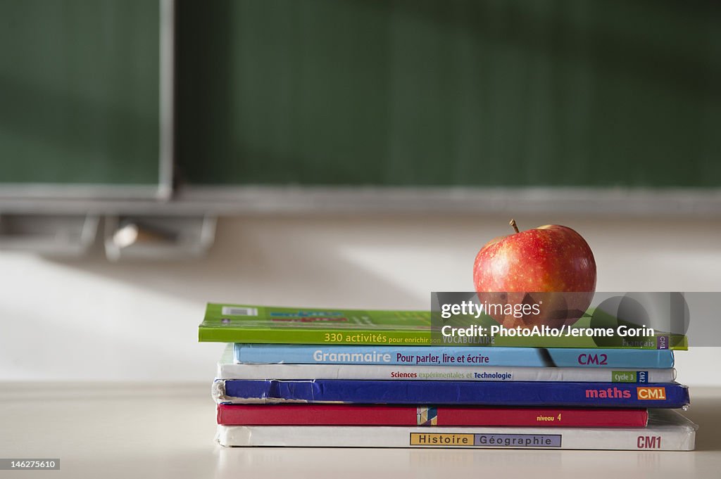 Apple on top of stacked books