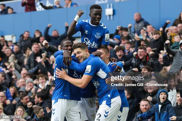 James Tarkowski of Everton celebrates with teammates after scoring his side's first goal during the Premier League match between Everton FC and...