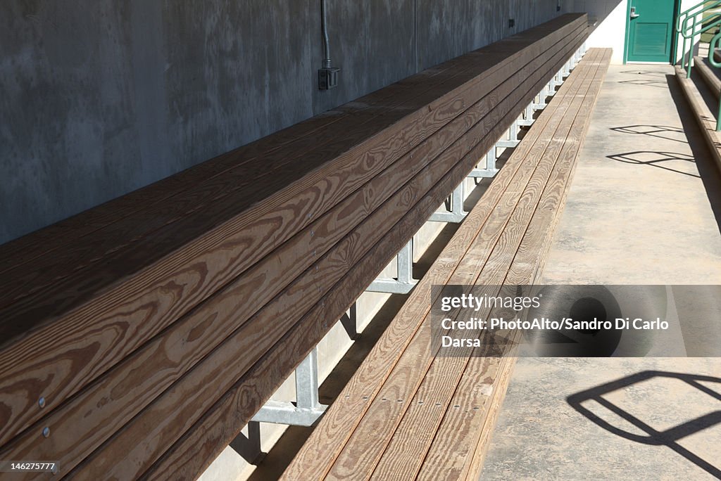 Empty bench in baseball dugout