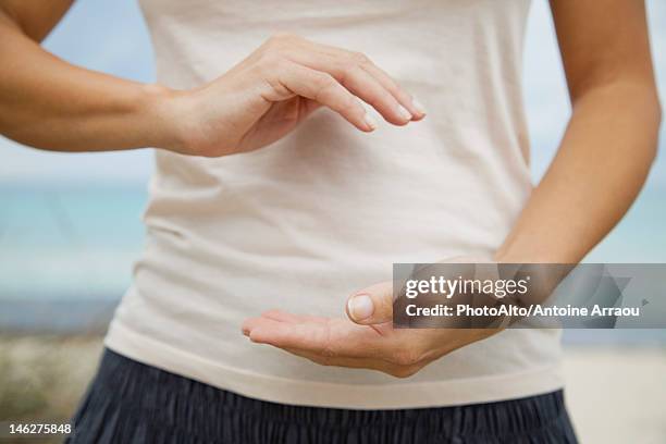 woman doing "hold the ball" tai chi chuan move, mid section - woman and tai chi stock pictures, royalty-free photos & images