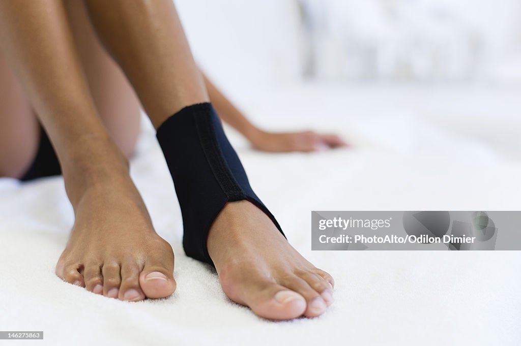 Woman wearing ankle brace, low section
