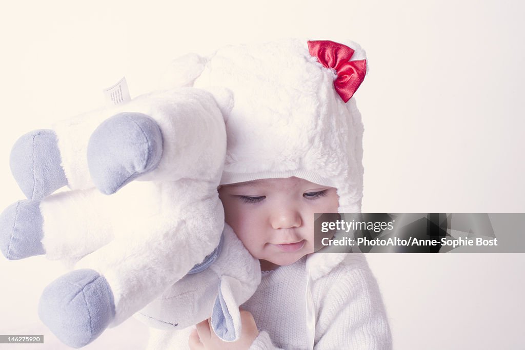 Baby girl hugging stuffed toy