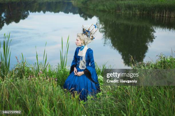 fairytale rococo queen with ship in hairstyle on nature. fine art portrait - blue dress stock pictures, royalty-free photos & images