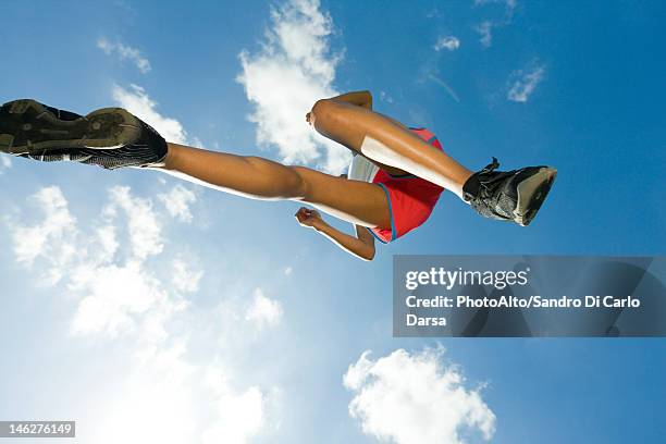 female athlete jumping in air, directly below - sole of shoe stock pictures, royalty-free photos & images