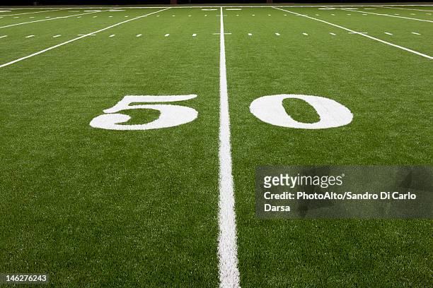 fifty yard line on football field - アメリカンフットボール場 ストックフォトと画像