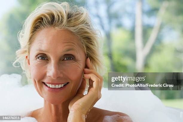 mature woman relaxing in bubble bath, portrait - wrinkled imagens e fotografias de stock