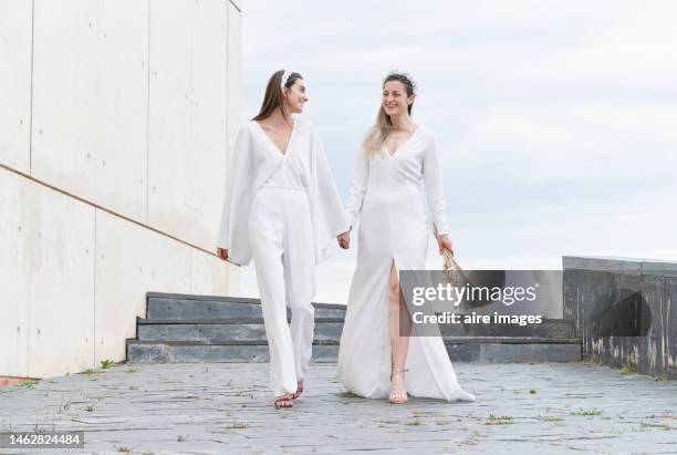 caucasian brides holding hands in a happy and smiling attitude. - wedding couple laughing stock pictures, royalty-free photos & images