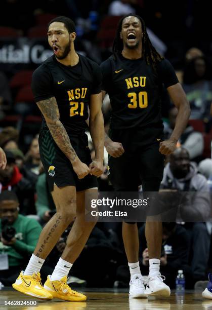 Dana Tate Jr. #21 and Kris Bankston of the Norfolk State Spartans celebrate in the second half against the Hampton Pirates during the Invesco QQQ...