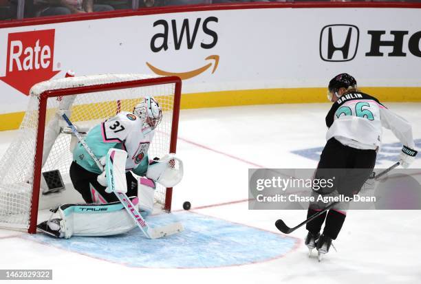 Connor Hellebuyck of the Winnipeg Jets makes a save on a penatly shot attempt by Rasmus Dahlin of the Buffalo Sabres during the final game between...
