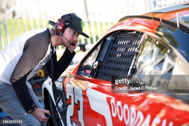 Retired NASCAR driver Kurt Busch and advisor to 23XI Racing speaks to Bubba Wallace, driver of the DoorDash Toyota, during practice for the NASCAR...