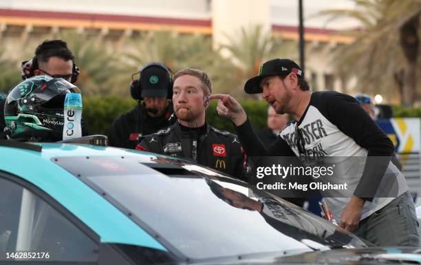 Retired NASCAR driver Kurt Busch and advisor to 23XI Racing speaks to Tyler Reddick, driver of the MoneyLion Toyota, during practice for the NASCAR...