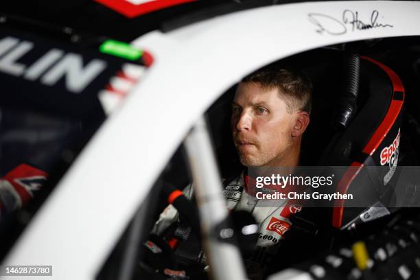 Denny Hamlin, driver of the Sport Clips Haircuts Toyota, sits in his car during qualifying for the NASCAR Clash at the Coliseum at Los Angeles...