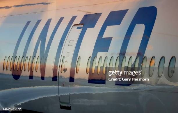 United Airlines airplanes sit parked at a gate at Terminal C at Newark Liberty Airport as the sun sets on February 3 in Newark, New Jersey.